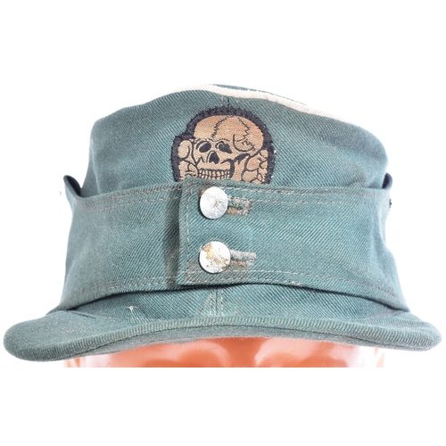 301 - A WWII Second World War Third Reich Nazi German Waffen SS forage cap with SS Death Skull logo to the... 