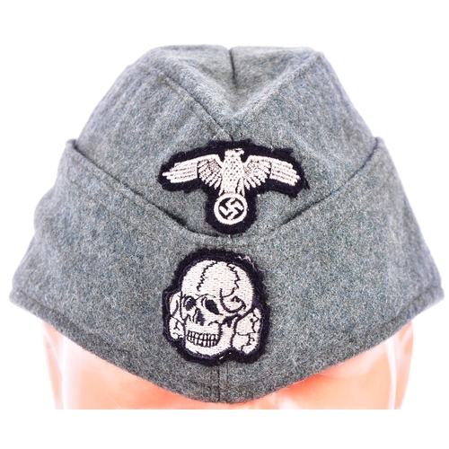 335 - A WWII Second World War style Third Reich Nazi German Waffen SS enlisted mans side cap. The cap with... 