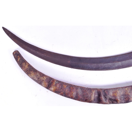 37 - A 19th Century East African native Ethiopian Shotel sword. Large sickle shaped blade with a central ... 