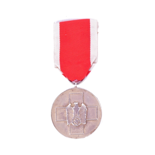 389 - A WWII Second World War Third Reich Nazi German Red Cross / Social Welfare medal suspended on red an... 