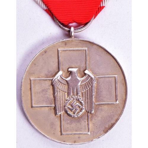 389 - A WWII Second World War Third Reich Nazi German Red Cross / Social Welfare medal suspended on red an... 