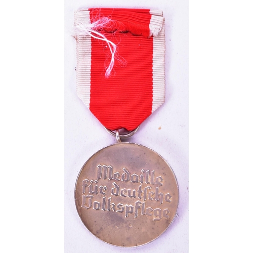 389 - A WWII Second World War Third Reich Nazi German Red Cross / Social Welfare medal suspended on red an... 