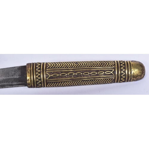 394 - A North African Berber Shula knife / tribal dagger. The pressed metal hilt and scabbard with geometr... 