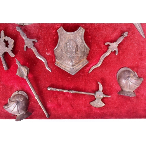 417 - A 20th Century display of miniature medieval style weapons and armour to include helmet, polearms, s... 