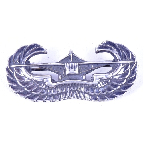 54 - A WWII Second World War US United States silver parachute glider wings. The badge depicting a front ... 