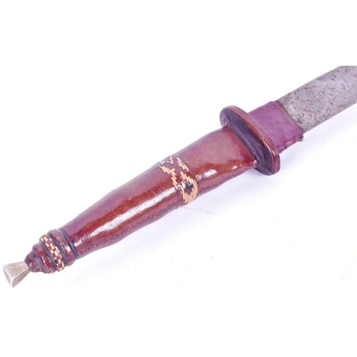 79 - A West African Mandinka People Takouba sword. Clad leather grip with a square section finial and a w... 