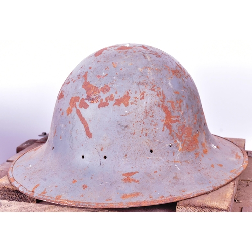 93 - A collection of militaria comprising x2 British WWII Second World War helmets ( Brodie and Zuckerman... 