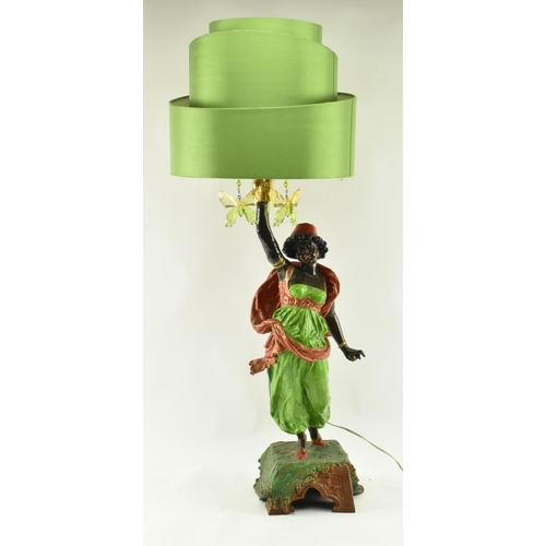 111 - A retro 20th century Blackamoor cast metal table lamp light. The lamp having a drum shaped green sha... 