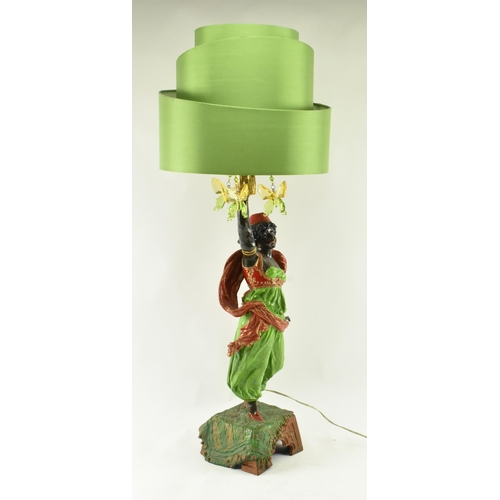 111 - A retro 20th century Blackamoor cast metal table lamp light. The lamp having a drum shaped green sha... 