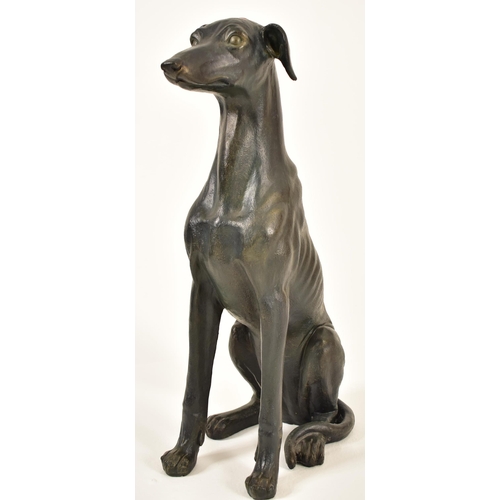 118 - A large 20th century Art Deco influenced resin model of a seated greyhound dog. The floor standing g... 