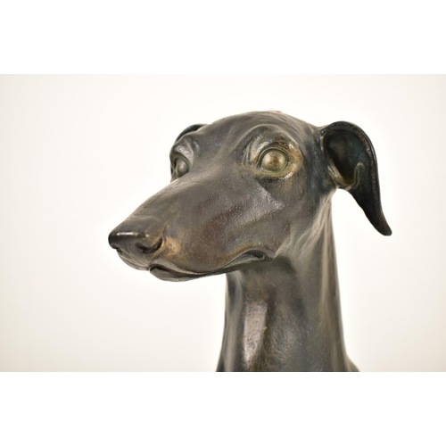 118 - A large 20th century Art Deco influenced resin model of a seated greyhound dog. The floor standing g... 