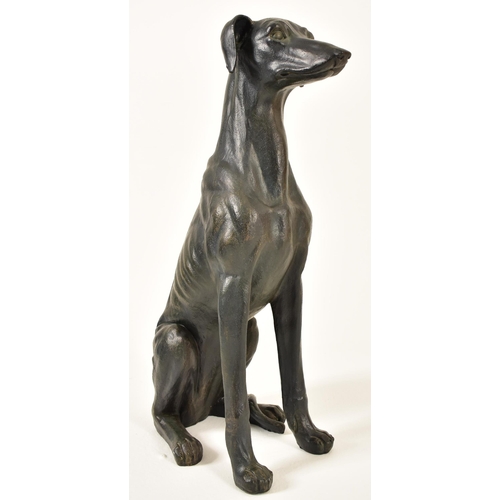 118 - A large 20th century Art Deco influenced resin model of a seated greyhound dog. The floor standing g... 