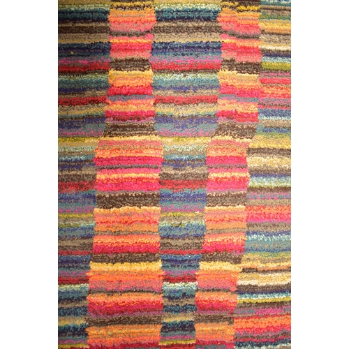 123 - A late 20th century multi coloured woollen floor carpet rug. The rug of rectangular form with multi ... 