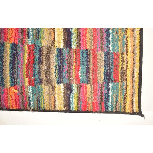 123 - A late 20th century multi coloured woollen floor carpet rug. The rug of rectangular form with multi ... 