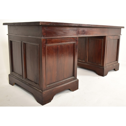 124 - A George III manner 20th century mahogany twin pedestal writing desk. The desk having a straight fla... 