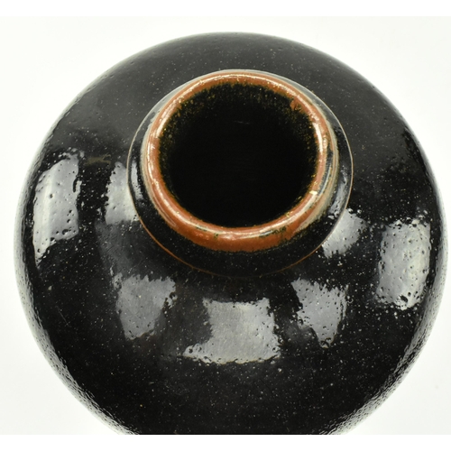 128 - Jim Malone (b. 1946) - A studio art pottery stoneware bottle baluster vase with Tenmoku glaze finish... 