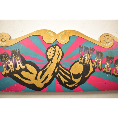 138 - Arm Wrestling - A 20th century fairground / funfair amusement park painted sign pediment. Shaped for... 