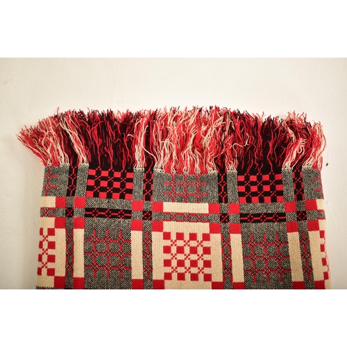 14 - A vintage 20th century hand made woollen traditional Welsh blanket. Red, cream, black and grey groun... 