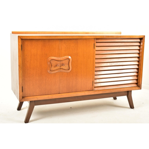 145 - A retro mid 20th century teak and walnut sideboard credenza. The sideboard having a double door cupb... 