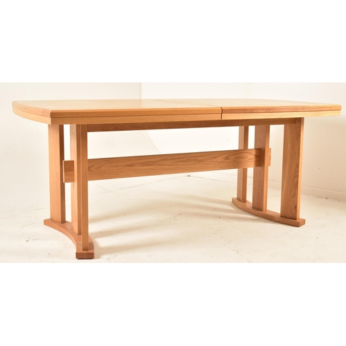 147 - A contemporary high end British design modern oak extending dining table. The table having a deep ch... 