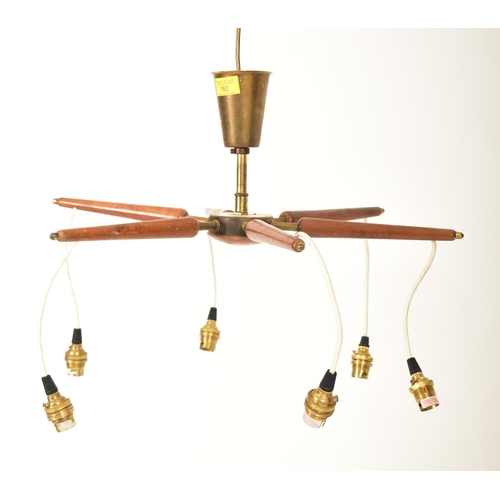 162 - A Danish retro mid 20th century teak & brass six arm ceiling light. The light having a conical brass... 