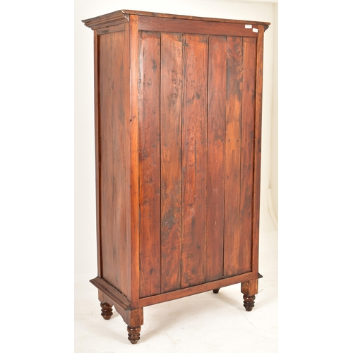 166 - A vintage 20th century hardwood wine cabinet on feet. The cabinet having a flared pediment atop over... 