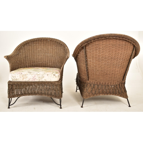 168 - A pair of retro 20th century wirework frame and wicker garden outdoor armchairs. Each chair having a... 