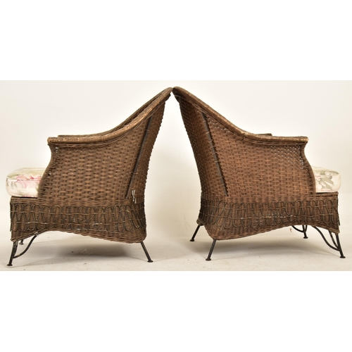 168 - A pair of retro 20th century wirework frame and wicker garden outdoor armchairs. Each chair having a... 