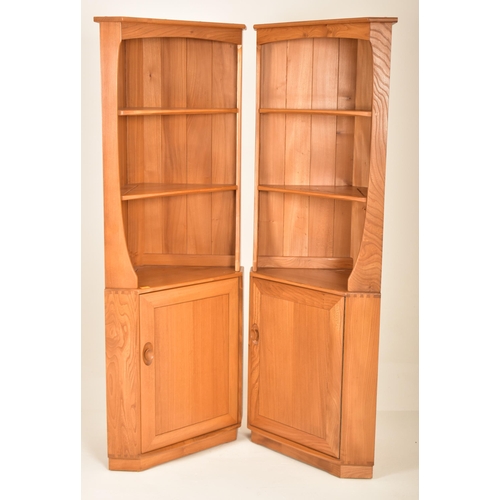 172 - Ercol - Windsor Model - A pair of retro 20th century blonde elm corner cabinets. The units having tw... 