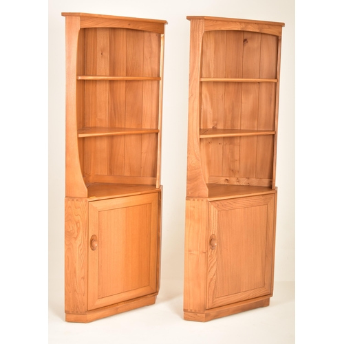 172 - Ercol - Windsor Model - A pair of retro 20th century blonde elm corner cabinets. The units having tw... 
