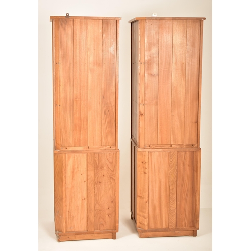 172 - Ercol - Windsor Model - A pair of retro 20th century blonde elm corner cabinets. The units having tw... 