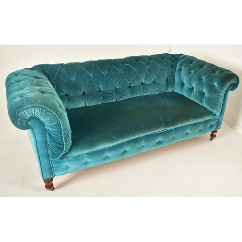 177 - An early 20th century re-upholstered chesterfield three seater sofa settee. The sofa having a scroll... 