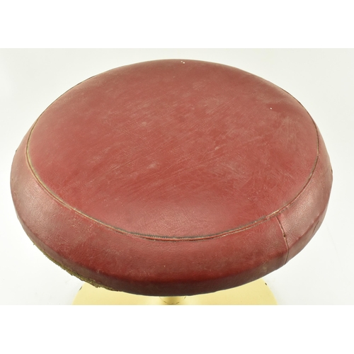 214 - A retro 20th century leather upholstered & metal Tulip manner stool. The stool having a circular pad... 