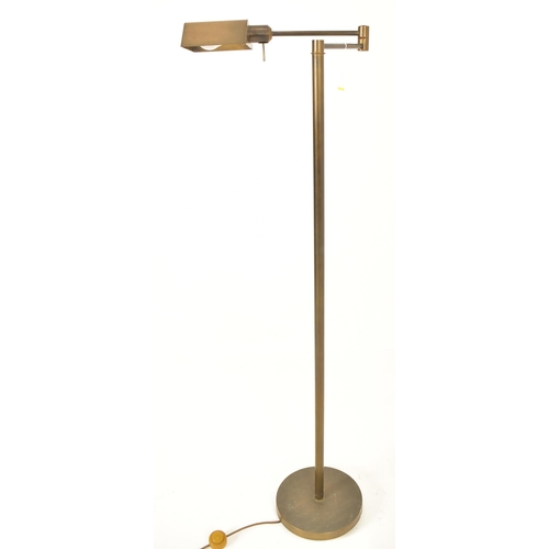 271 - A retro 20th century 1960s inspired brassed metal floor standard lamp. The lamp having a shaped shad... 