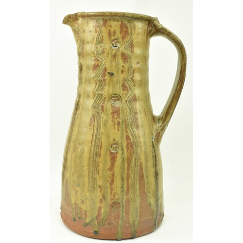 273 - Jim Malone (b. 1946) - A large studio art pottery stoneware single handled jug. The jug having textu... 