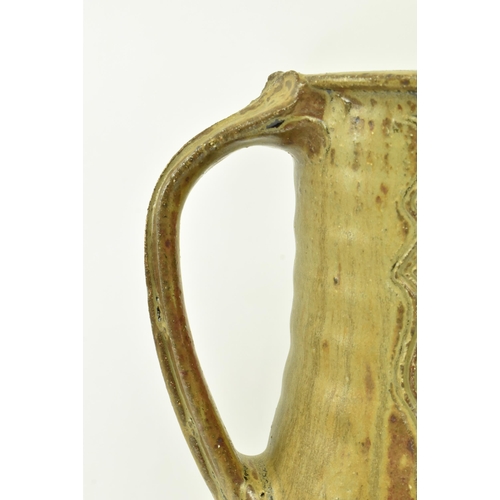 273 - Jim Malone (b. 1946) - A large studio art pottery stoneware single handled jug. The jug having textu... 