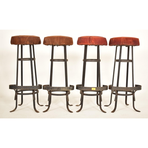 276 - A set of four retro 20th century suede leather & wrought iron bar stools. Each having a circular pad... 