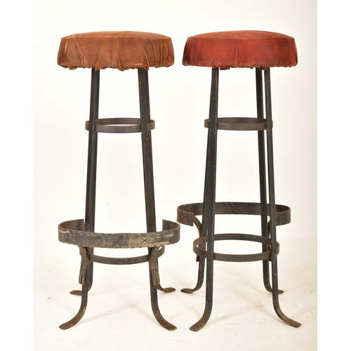 276 - A set of four retro 20th century suede leather & wrought iron bar stools. Each having a circular pad... 