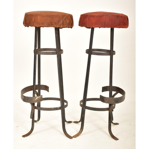 276 - A set of four retro 20th century suede leather & wrought iron bar stools. Each having a circular pad... 