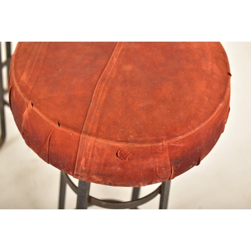 276 - A set of four retro 20th century suede leather & wrought iron bar stools. Each having a circular pad... 