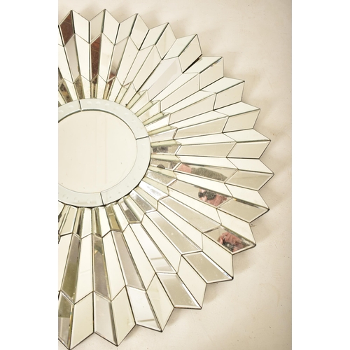 37 - A vintage late 20th century Art Deco influenced designer hanging mirror of starburst form. Central m... 