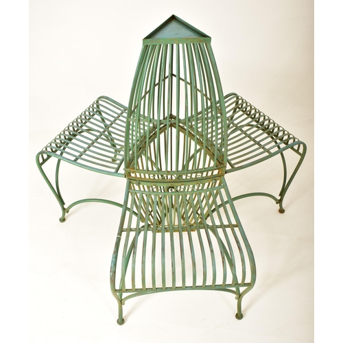 443 - A contemporary Victorian style three seater garden bench of wrought iron construction. Spindle back ... 