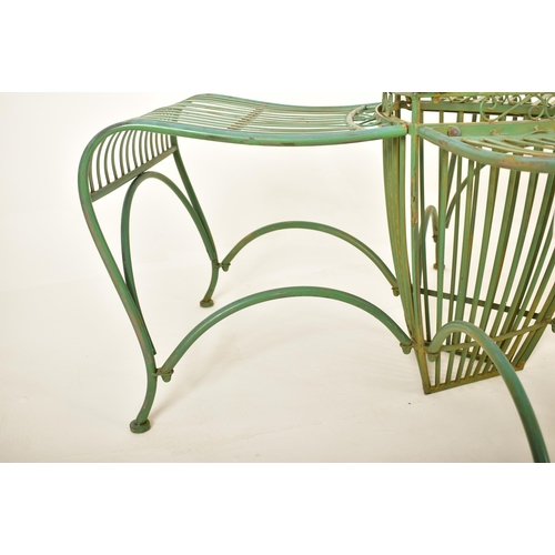 443 - A contemporary Victorian style three seater garden bench of wrought iron construction. Spindle back ... 