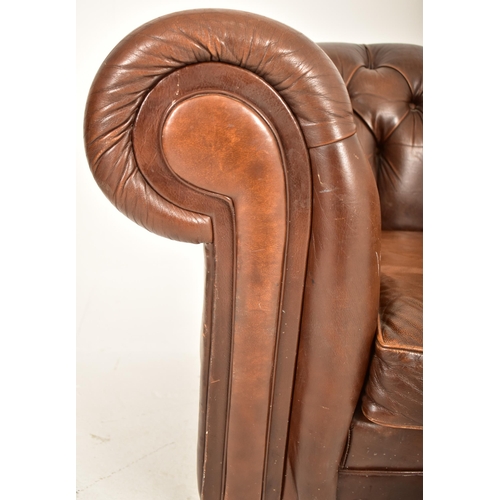 45 - A contemporary brown leather Chesterfield button backed two seater sofa settee. The sofa having a sc... 