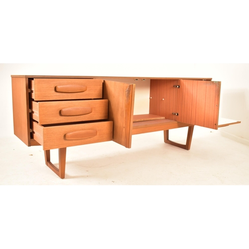 522 - A retro 20th century British modern designer teak sideboard credenza. The sideboard having a central... 