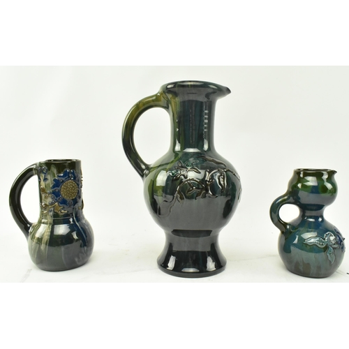 57 - Sir Edmund Harry Elton - Elton Ware Pottery, Clevedon - Three studio art pottery glazed handled jugs... 