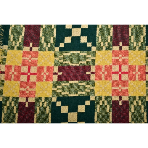 66 - A vintage 20th century hand made woollen traditional Welsh blanket. Dark green, pink / burgundy, yel... 