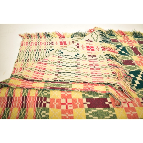 66 - A vintage 20th century hand made woollen traditional Welsh blanket. Dark green, pink / burgundy, yel... 