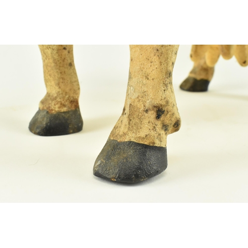 79 - A large contemporary heavy cast iron model of a cow. The door stop cow standing with painted feature... 