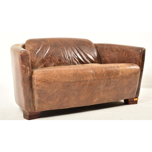 92 - A contemporary British designer two seater sofa settee. The sofa having a canted curved backrest wit... 